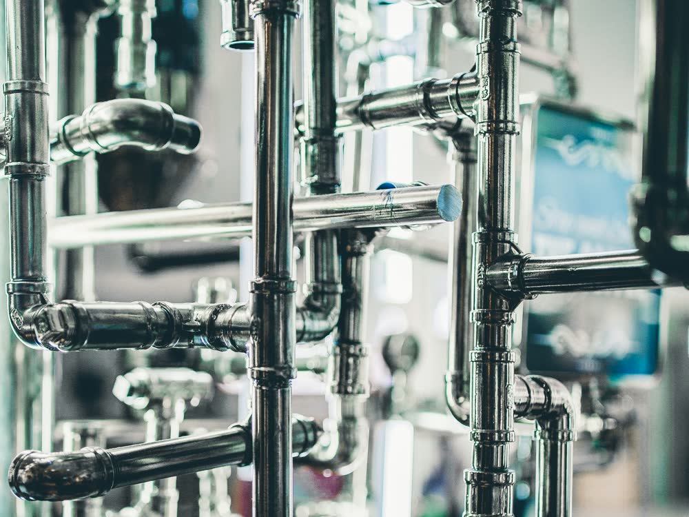 A manifold of copper and chrome supply pipework